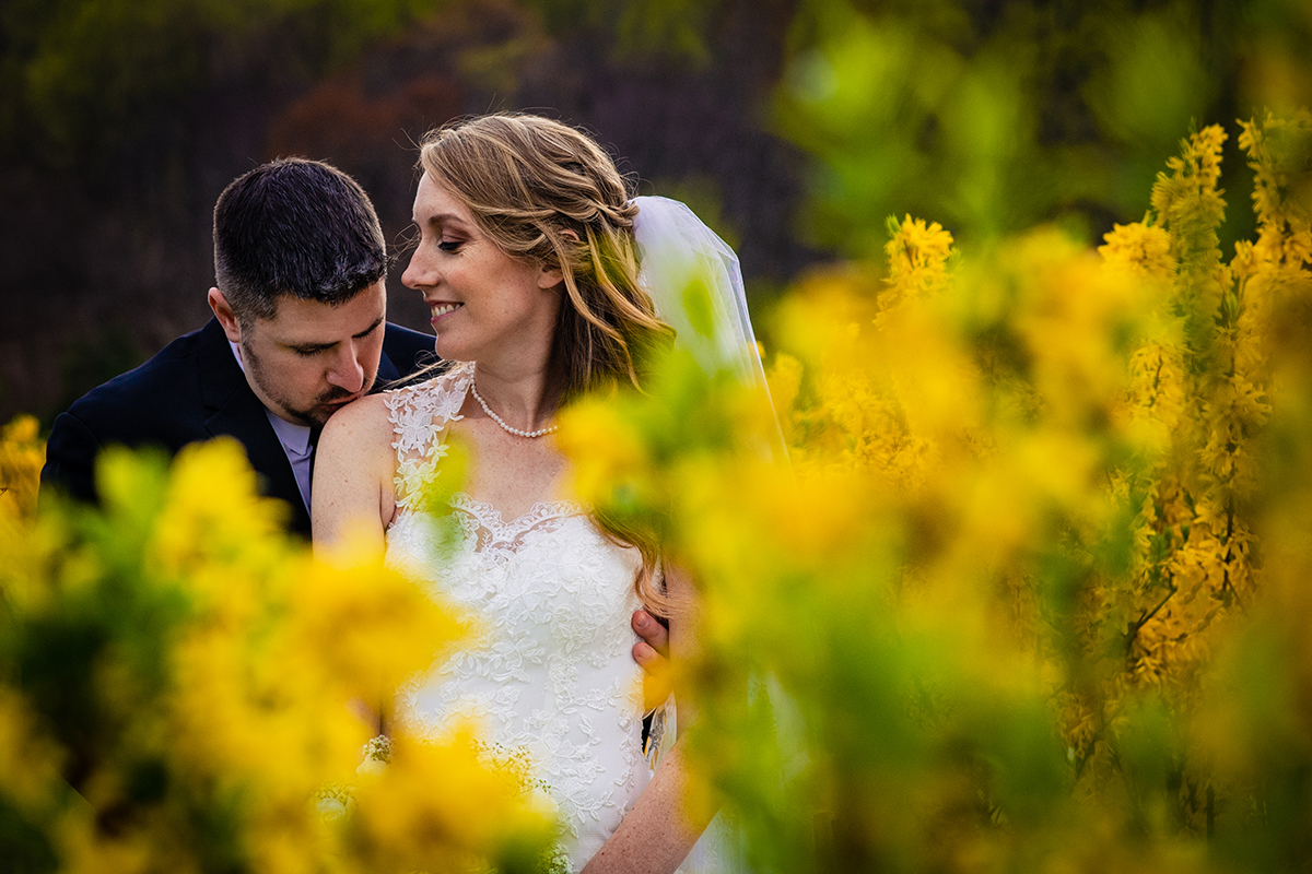 Wedding day timeline: Outdoor bride and groom portrait with yellow flowers at Springfield Manor in Maryland by DC wedding photographer Potok's World Photography