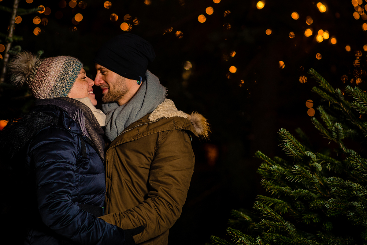 Tips for planning a winter engagement photoshoot at the Christmas market with seasonal lights by DC wedding photographer Potok's World Photography