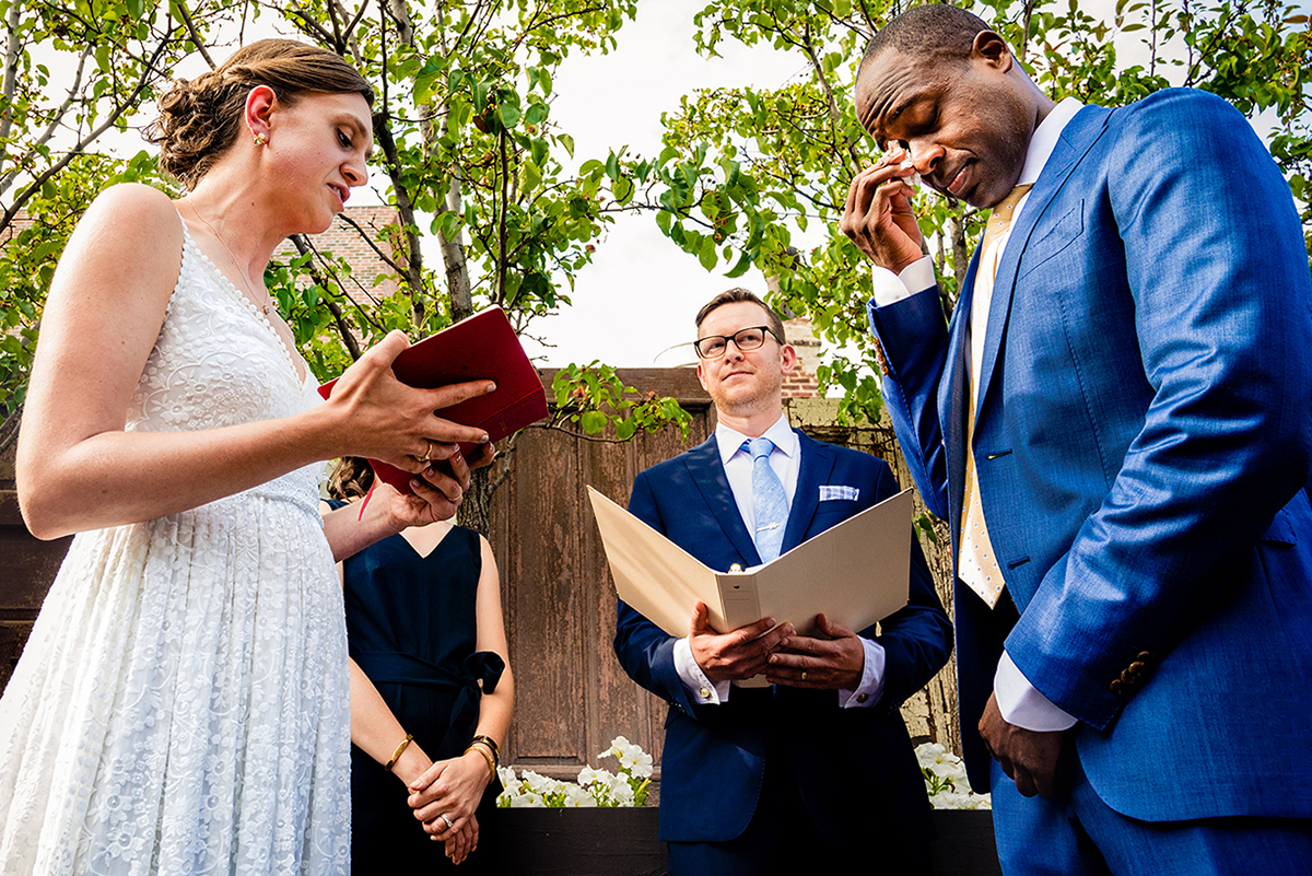 Couple exchanging vows at outdoor wedding ceremony at Fathom Gallery in DC by Potok's World Photography