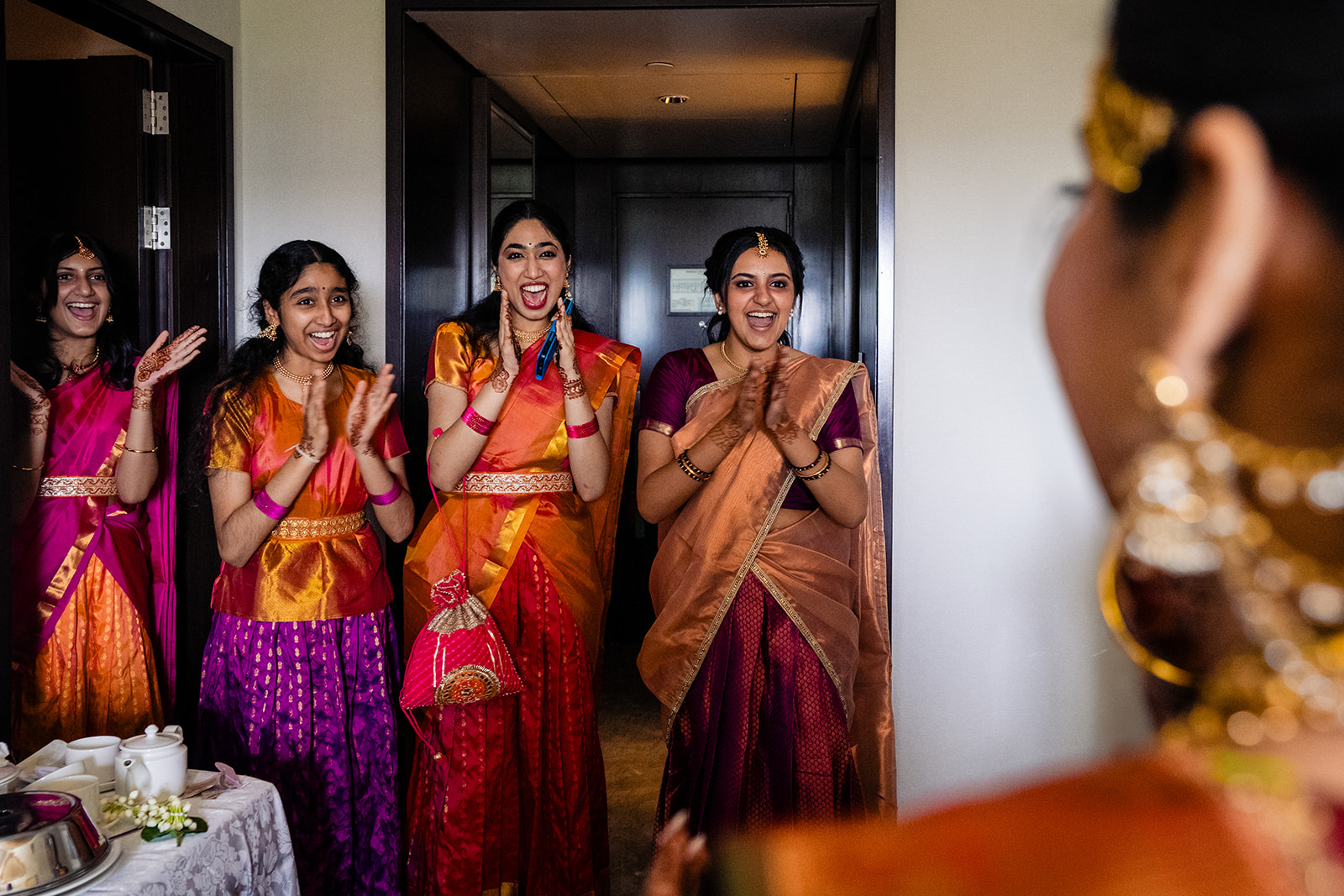 South Indian bride's first look with her bridesmaids before her wedding ceremony at Taj Coromandel Chennai by Potok's World Photography