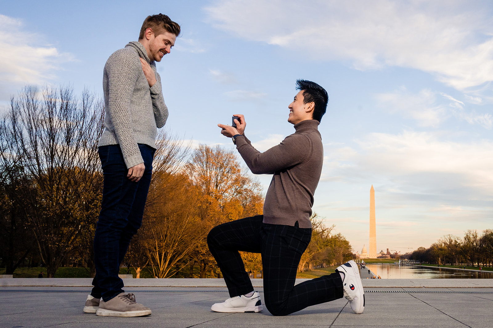 Same sex couple proposing at the Lincoln Memorial with the Reflecting Pool and the Washington Monument in the background by Potok's Word Photography